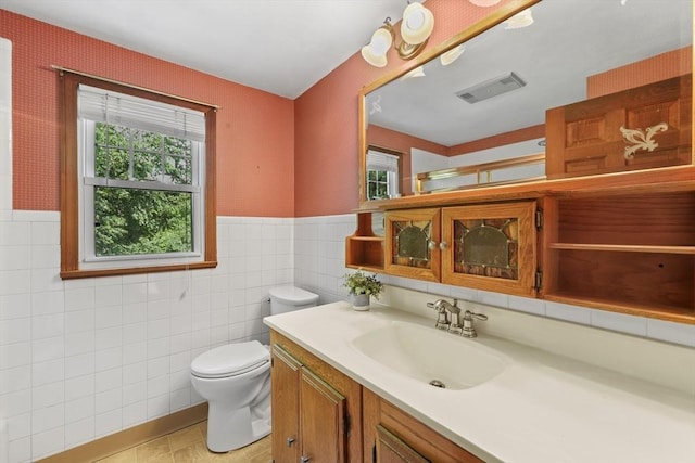 45 Donamor Ln, East Longmeadow, MA 01028 - full bath featuring toilet, vanity, tile walls, a wainscoted wall, and an enclosed shower