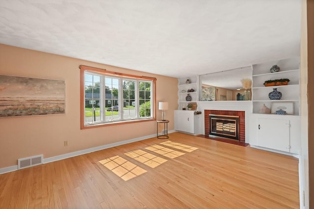 45 Donamor Ln, East Longmeadow, MA 01028 - unfurnished living room with wood finished floors, baseboards, and a fireplace