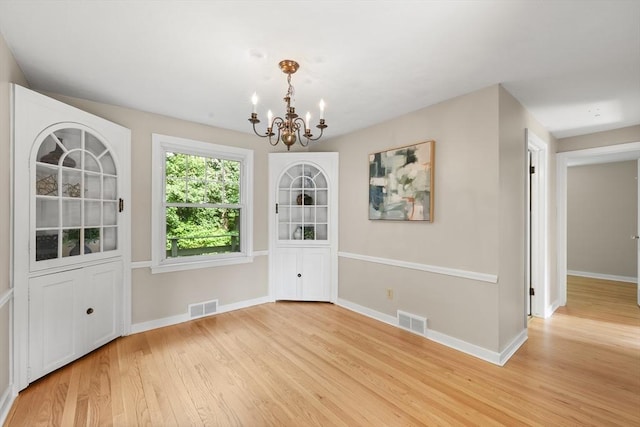 45 Donamor Ln, East Longmeadow, MA 01028 - unfurnished dining area featuring light wood-style floors, a chandelier, and baseboards