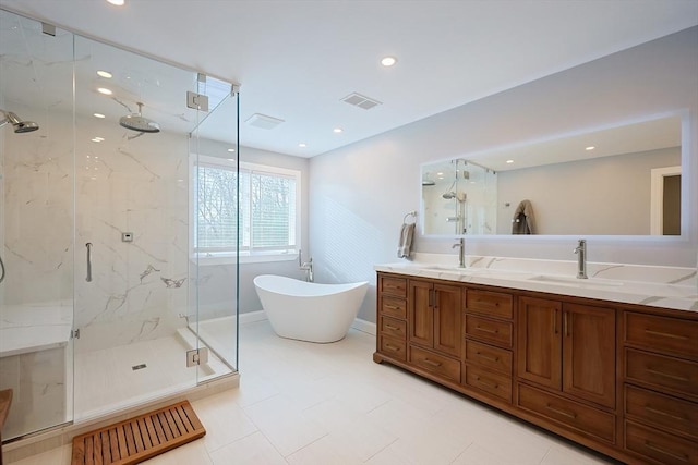 bathroom featuring a marble finish shower, a soaking tub, a sink, and visible vents