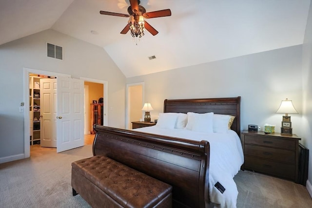 bedroom with a ceiling fan, visible vents, vaulted ceiling, and light carpet