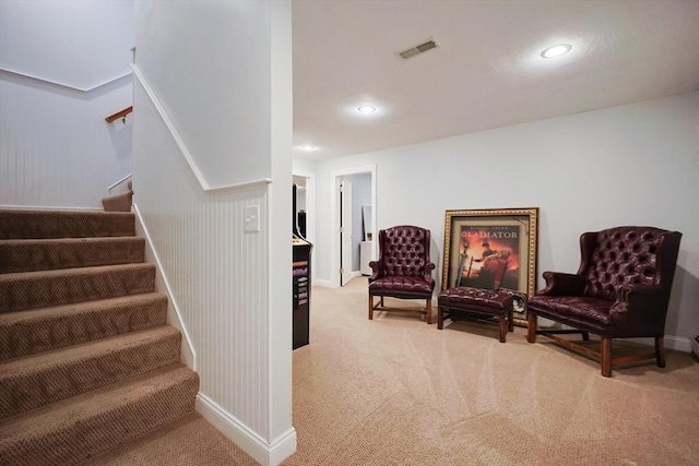 sitting room with carpet floors, recessed lighting, visible vents, baseboards, and stairs