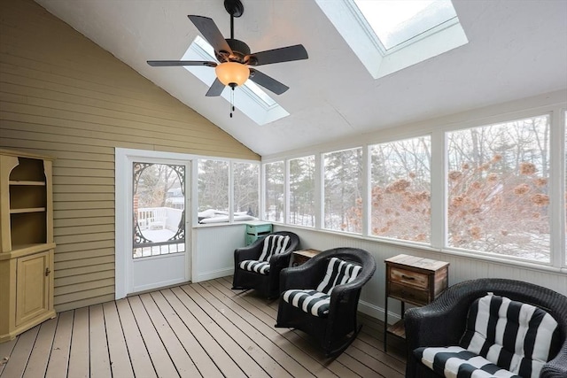 sunroom featuring lofted ceiling with skylight and a ceiling fan