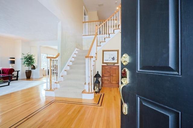 foyer with stairway and wood finished floors