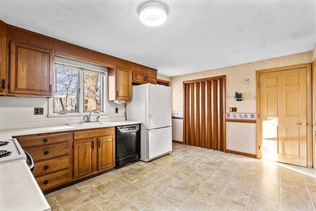 kitchen with white refrigerator, sink, stove, and black dishwasher