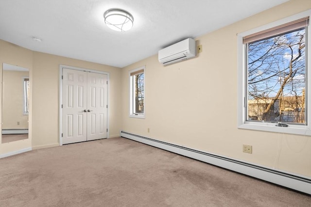 unfurnished bedroom featuring a wall mounted air conditioner, a closet, light colored carpet, and a baseboard heating unit