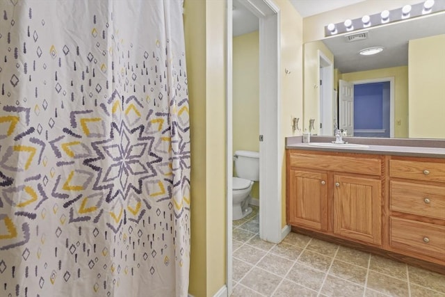 96 Caspian Way Unit 96, Fitchburg, MA 01420 - bathroom featuring toilet, vanity, baseboards, tile patterned flooring, and a shower with shower curtain