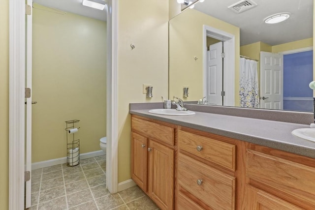 96 Caspian Way Unit 96, Fitchburg, MA 01420 - bathroom with toilet, double vanity, and baseboards