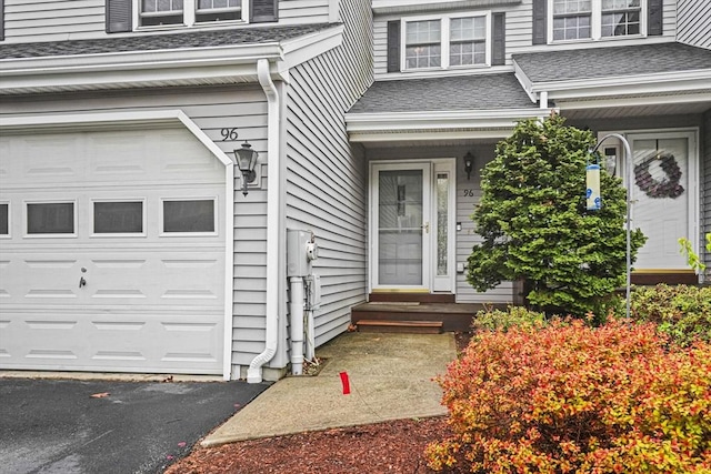 96 Caspian Way Unit 96, Fitchburg, MA 01420 - view of exterior entry with roof with shingles and an attached garage