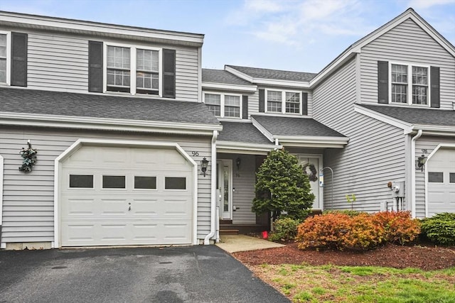 96 Caspian Way Unit 96, Fitchburg, MA 01420 - view of front of home with an attached garage, roof with shingles, and asphalt driveway
