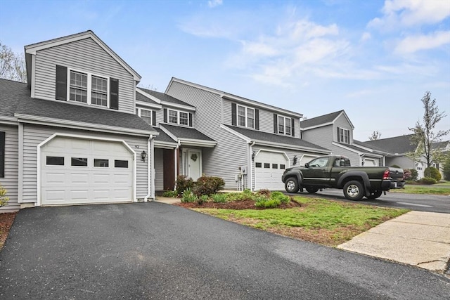 96 Caspian Way Unit 96, Fitchburg, MA 01420 - view of front facade featuring asphalt driveway, an attached garage, and a residential view