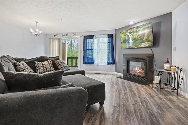96 Caspian Way Unit 96, Fitchburg, MA 01420 - living room with wood finished floors, a fireplace with flush hearth, baseboards, and a chandelier