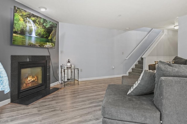 96 Caspian Way Unit 96, Fitchburg, MA 01420 - living area featuring wood finished floors, a glass covered fireplace, stairs, and baseboards