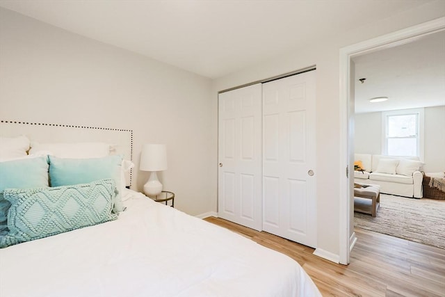 bedroom with a closet and light hardwood / wood-style flooring