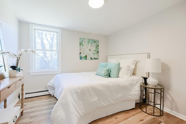 bedroom featuring light hardwood / wood-style floors and baseboard heating