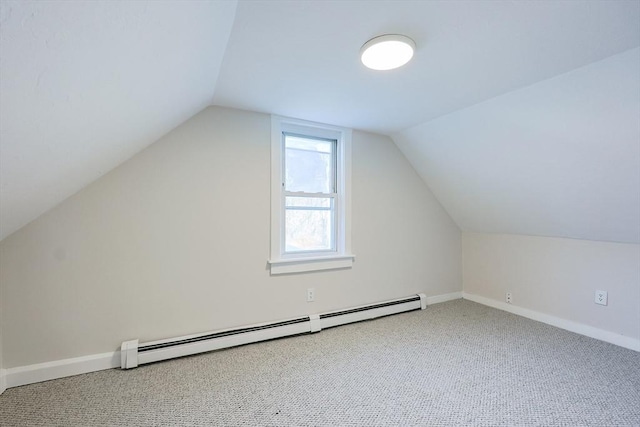 additional living space with carpet floors, a baseboard heating unit, and vaulted ceiling