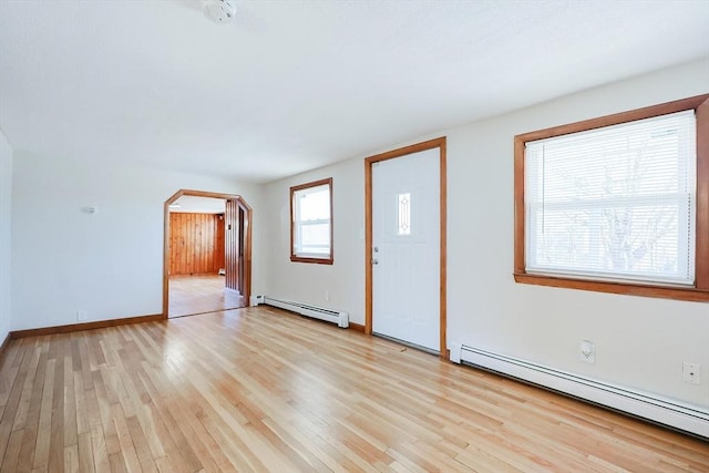 foyer entrance featuring a baseboard radiator and light wood-type flooring