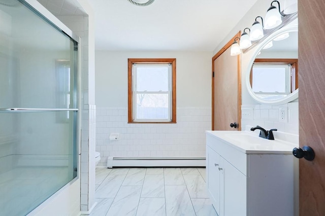 bathroom with vanity, a baseboard heating unit, tile walls, and toilet