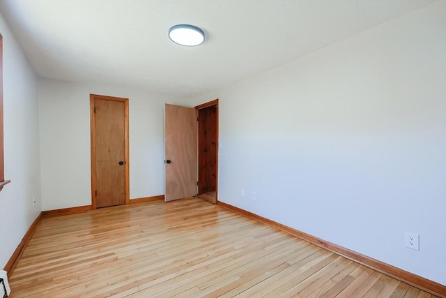 unfurnished room with light hardwood / wood-style floors