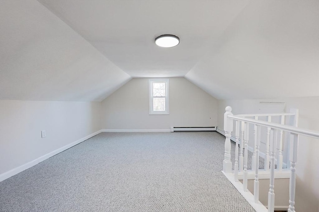 additional living space with lofted ceiling, carpet flooring, and a baseboard heating unit