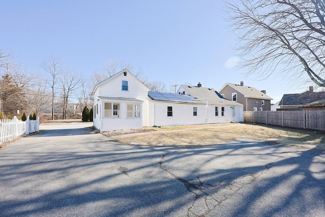 back of property featuring solar panels