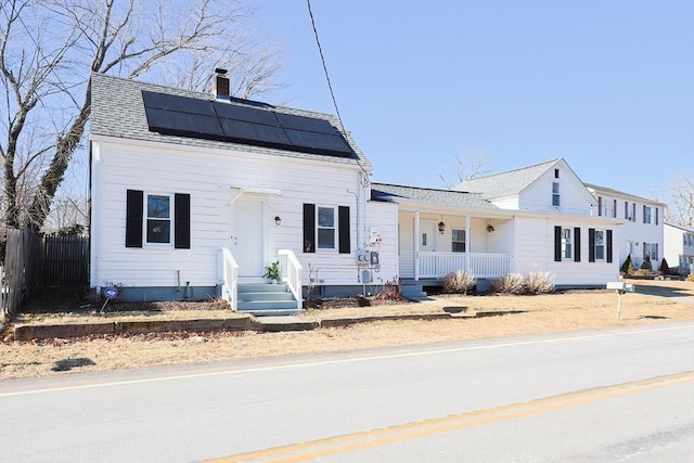 view of front facade featuring covered porch and solar panels