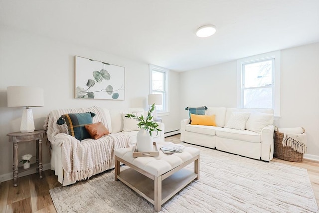 living room featuring hardwood / wood-style flooring and baseboard heating