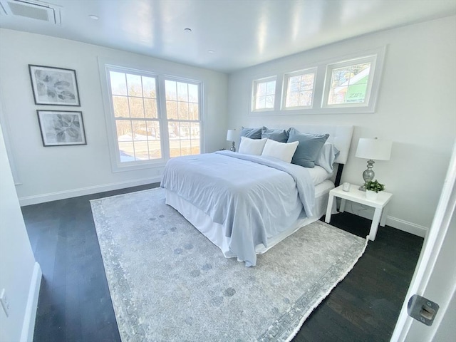 bedroom with dark hardwood / wood-style flooring