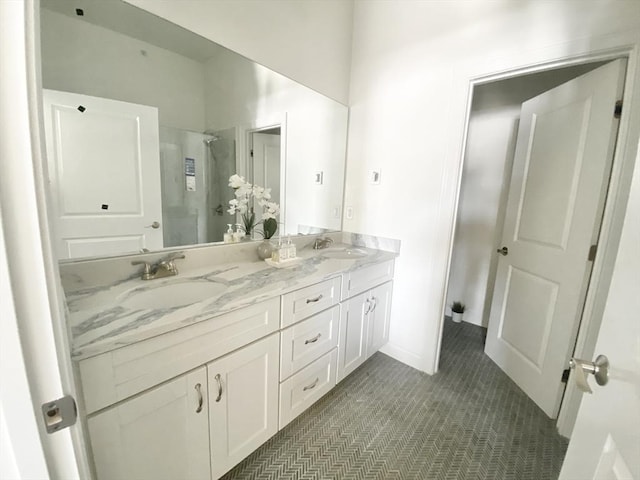 bathroom featuring tile patterned floors, vanity, and a shower with door