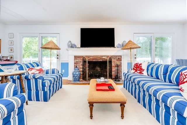 living room with a fireplace and ornamental molding