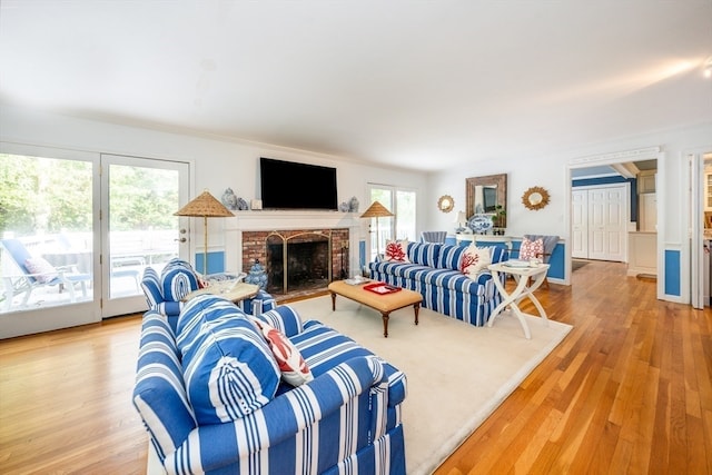 living room with a fireplace and light hardwood / wood-style flooring