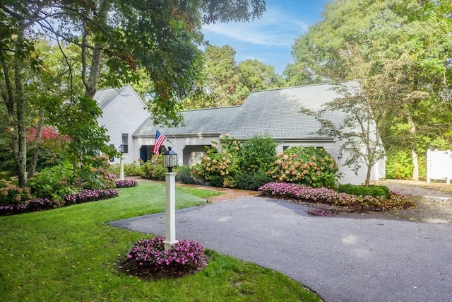 view of front of home with a front lawn and a garage