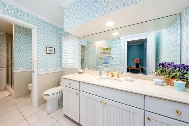 bathroom featuring tile patterned flooring, a shower with door, crown molding, vanity, and toilet