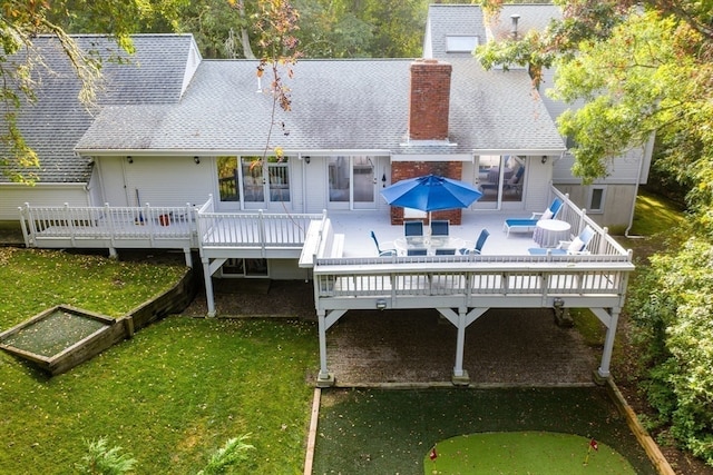 rear view of property with a lawn, a patio, and a deck