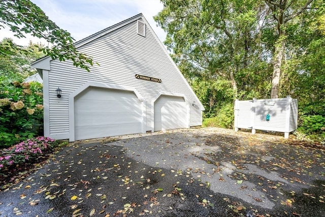 view of side of property with an outdoor structure and a garage