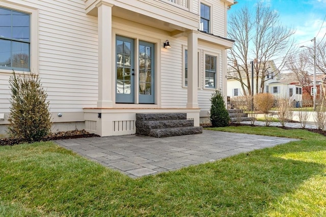 view of exterior entry featuring a yard