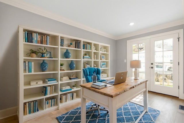 office space with ornamental molding, french doors, and light wood-type flooring