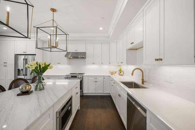 kitchen featuring appliances with stainless steel finishes, a sink, under cabinet range hood, recessed lighting, and white cabinetry