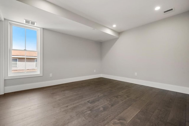 below grade area featuring baseboards, dark wood-type flooring, and recessed lighting