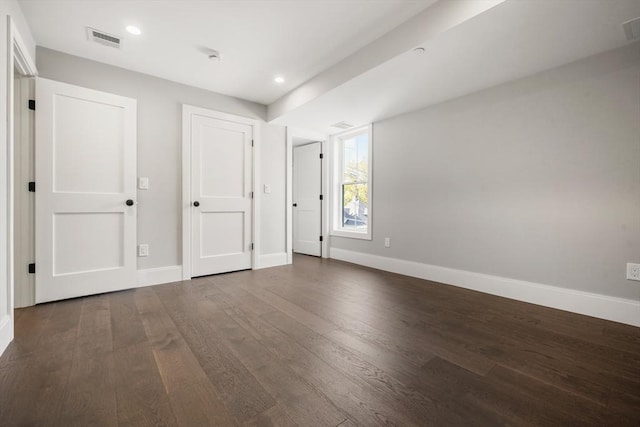 unfurnished bedroom with baseboards, wood finished floors, and recessed lighting
