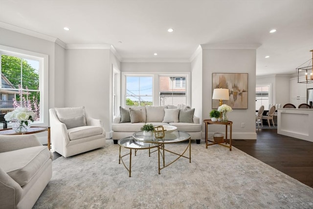 living area featuring wood finished floors, baseboards, recessed lighting, and crown molding
