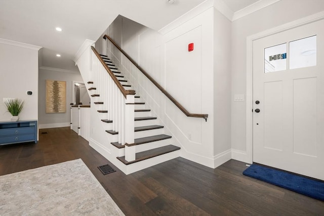 foyer entrance featuring crown molding, baseboards, wood finished floors, stairway, and recessed lighting