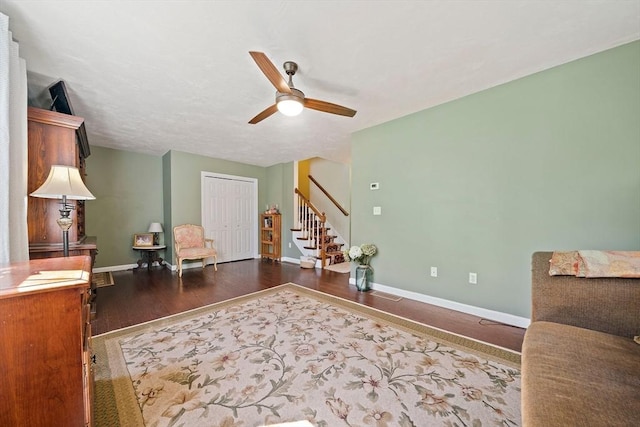 interior space with visible vents, stairs, wood finished floors, baseboards, and a ceiling fan