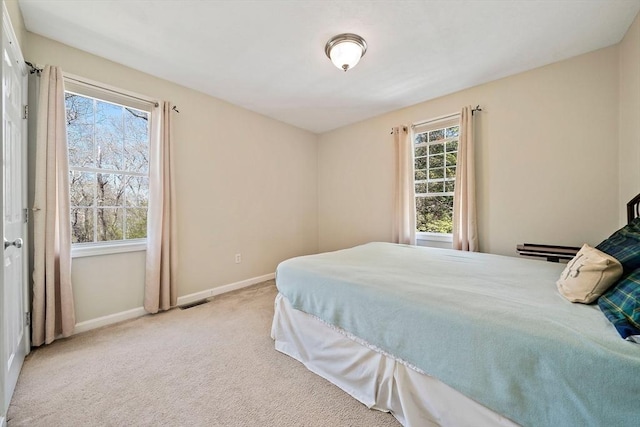 bedroom with baseboards, carpet, and visible vents