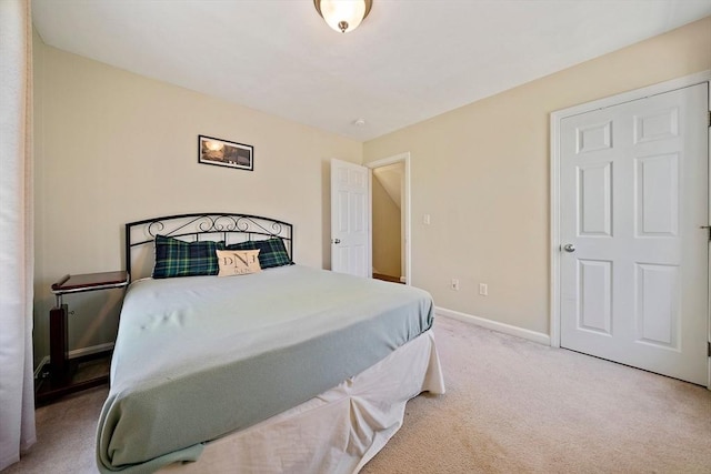 bedroom featuring baseboards and carpet