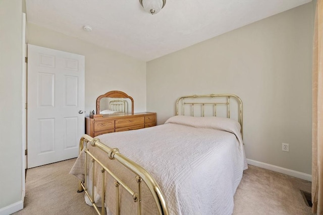 bedroom with baseboards and light colored carpet