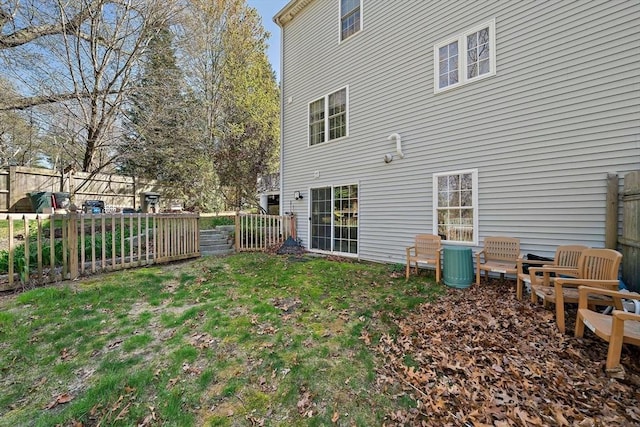 back of house with a lawn, a fenced backyard, and central air condition unit