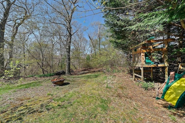 view of yard with a playground and a fire pit