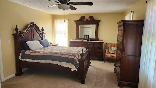 bedroom featuring a ceiling fan and light colored carpet