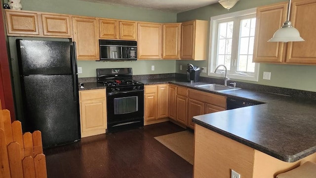 kitchen featuring dark wood-style flooring, dark countertops, a sink, and black appliances